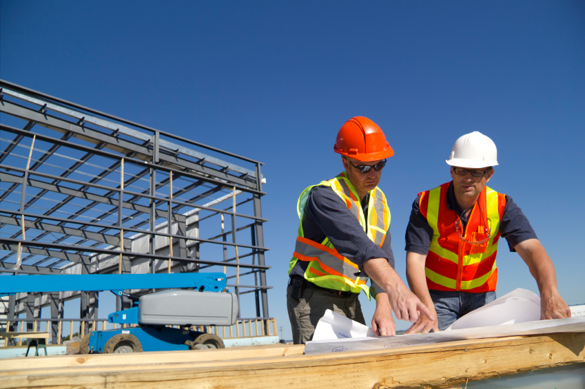 Two men looking at construction blueprints